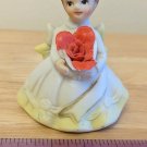 VTG Birthday Girl Figurine, Brunette in Yellow Dress, Holding Red Rose (chipped)