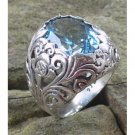 Silver ring bun flower motif with blue topaz stone