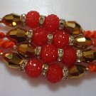 Coral Rakhi With Gold Tone Crystal Clear Stones By Teknowear