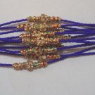 Multi Color Crystal Rakhi/Bracelet in Gold Tone Knoted With Beads By Teknowear