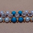 Dual Colored Rakhi in Turquoise & Amethyst With Clear Crystals By Teknowear