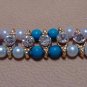 Dual Colored Rakhi in Turquoise & Amethyst With Clear Crystals By Teknowear