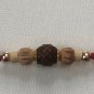 Rudraksha Rakhi With Turmeric & Basil Beads by Teknowear