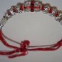 Rakhi in Silver With Glass Beads & Red Crystals By Teknowear