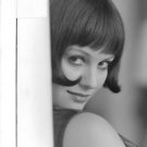 Claudia Cardinale glancing from behind a wall. - 8x10 photo