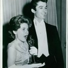 Patty Duke holding her Oscar prize statue and George Chakiris standing beside he