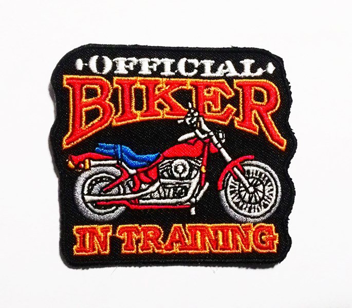 The official biker in training iron on patch.
