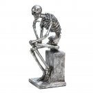 the thinker skeleton statue