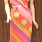 Vintage TNT Barbie dark haired with 70's style dress.