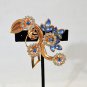 COPPER TONE BLUE AND CRYSTAL STONE FLORAL BROOCH