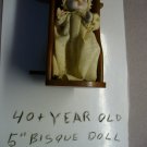5" bisque collectable doll with wood cradel
