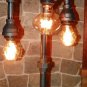 Handcrafted Industrial Pipe Three Tier Lamp steampunk style with vintage bulb