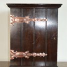 A small Arts and Crafts mahogany cabinet with copper strap hinges