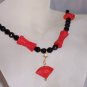 Carved "cinnabar" with jet beads