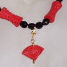 Carved "cinnabar" with jet beads