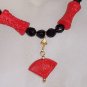 Carved "cinnabar" with jet beads