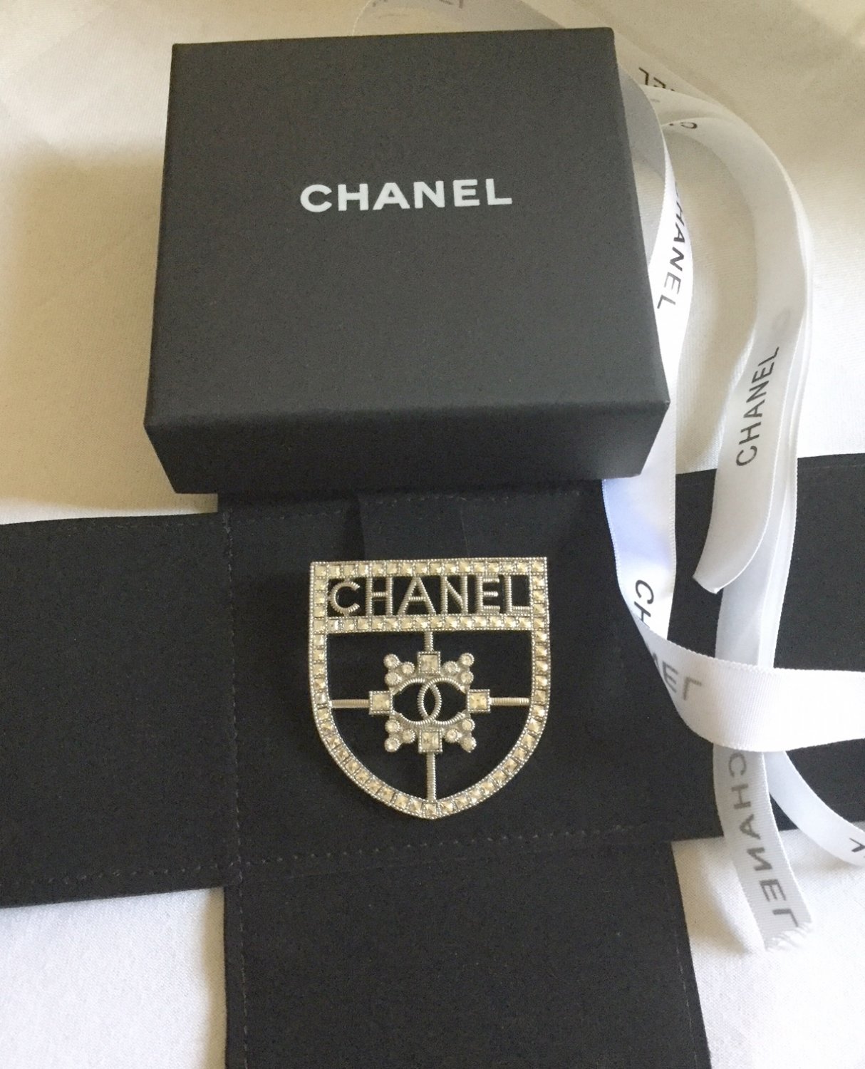 chanel shield brooch
