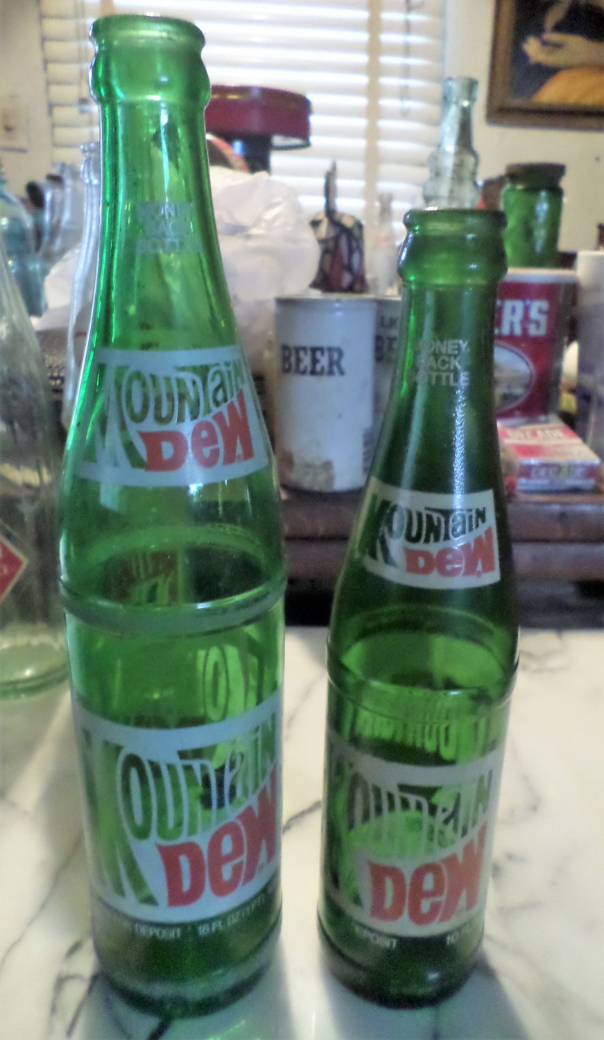 2 Vintage 1970s Mountain Dew soda bottles. one 16oz., one 10oz. Collectible