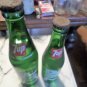 2 Vintage 1980s 7-UP full contents soda bottles. 16oz and 10oz. ex. cond.
