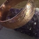 Solid Copper Bangle 7/8 Of An Inch wide. Will fit a 6 1/2 to 7 inch wrists. Solid Copper Bangle 7/8 Of An Inch wide. Will fit a 6 1/2 to 7 inch wrists.