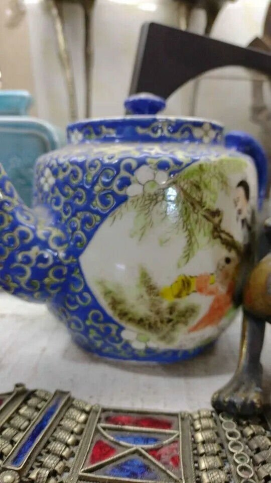 old multicolored china porcelain teapot broken lid