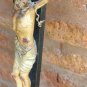 Antique old Jesus Christ on wooden cross. polychrome paper mache. breaks