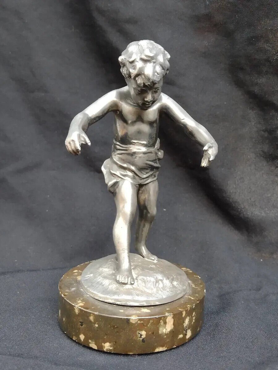 old silver metal boy figure with marble base