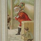 Christmas Postcard Santa Claus boys hold string try to trip Santa Posted Divided