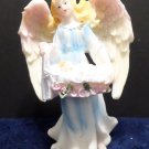 Christmas Figurine Angel carrying a Baby  made of resin