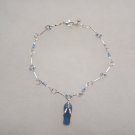 Silver Tone Metal Bracelet with Blue Glass Beads and Sandal Charm