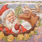 1908 Christmas postcard Santa Claus feeding candy cane to reindeer unposted