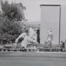 Black and White Photograph of a Man and a Baby Riding Small Scale Train Original