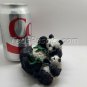 Cute momma and baby panda kicking back munching on leaves (figurine)