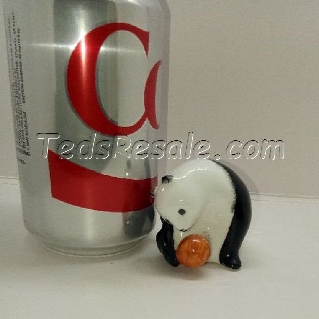 Panda playing with a ball. (figurine)