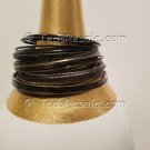 A Group of 24 Shades of Black Stacking Bracelets