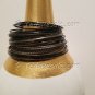 A Group of 24 Shades of Black Stacking Bracelets