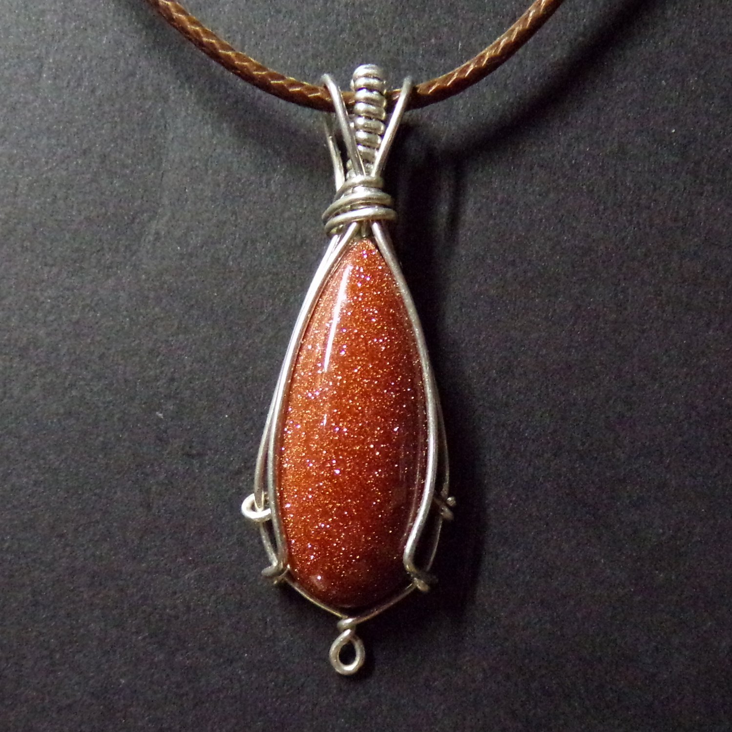 gold stone pendant wrapped in silver