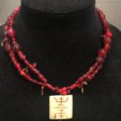 Burgundy beaded necklace with Cream pendant.    N-1