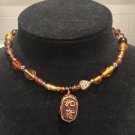 Brown beaded necklace with brown bead pendant.     N-5