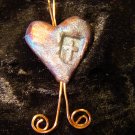 raku heart with cross pendant