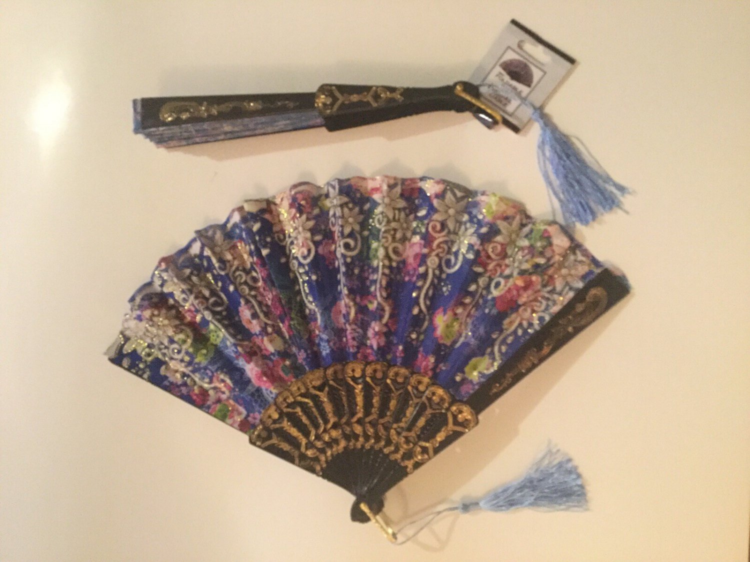 2 floral hand fans foldable cloth metallic tassel 9 in plastic