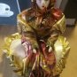 Porcelain Clown Jester Dolls sits on heart pillow music box