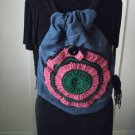 Upcycled and Reconstructed Jean Drawstring Bag With a Bright Crocheted pocket front.