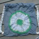 Upcycled and Reconstructed Jean Drawstring Bag With a Bright Crocheted pocket front.