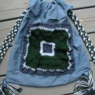 Upcycled and Reconstructed Jean Drawstring Bag With a Bright Crocheted pocket front.