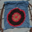 Upcycled and Reconstructed Jean Drawstring Bag With a Bright Crocheted pocket front.