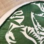Unique round green and off white Otomi pouf.