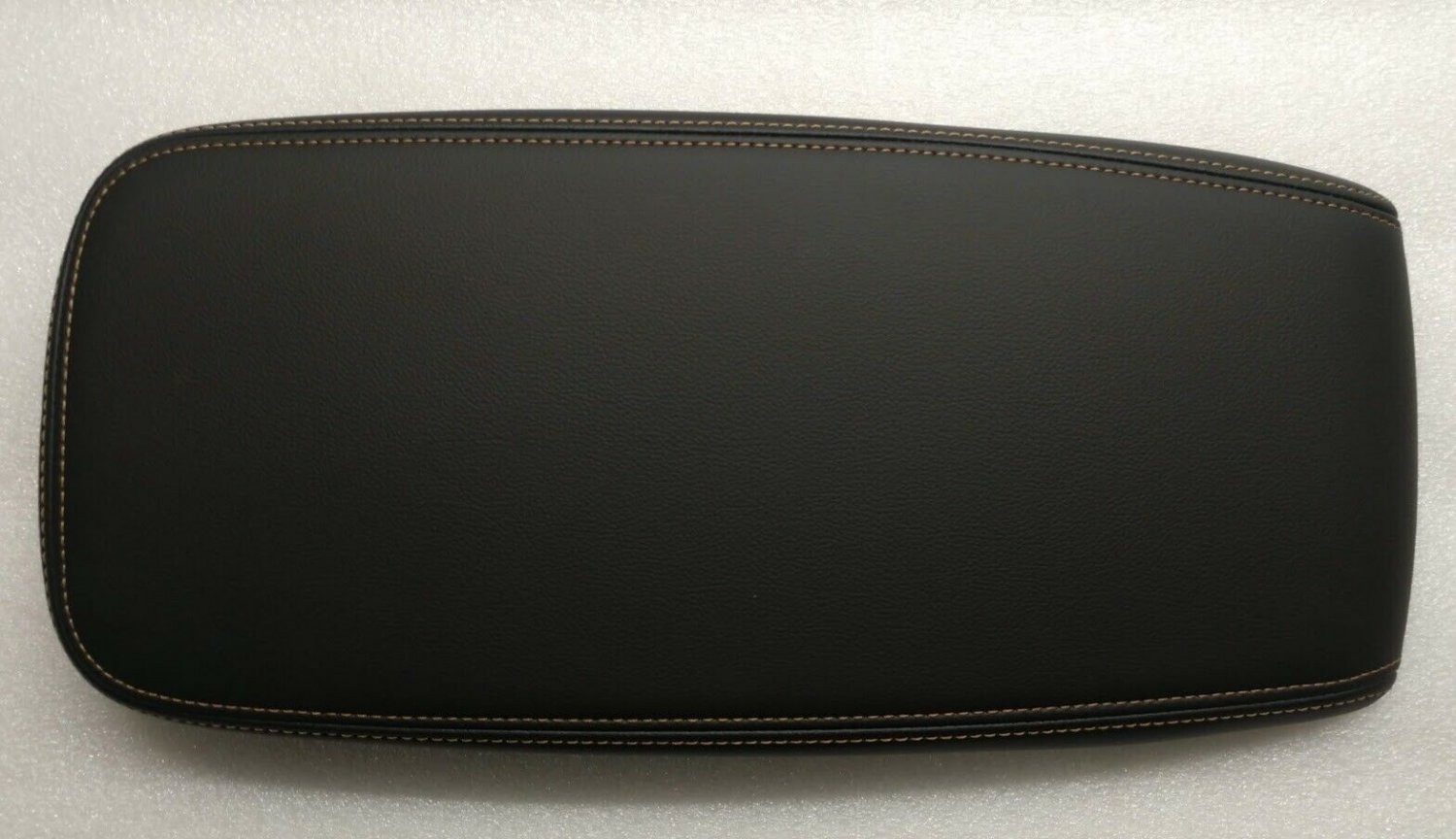 Volt 2016-2019 black leather center console lid armrest. Tan stitching. OEM New