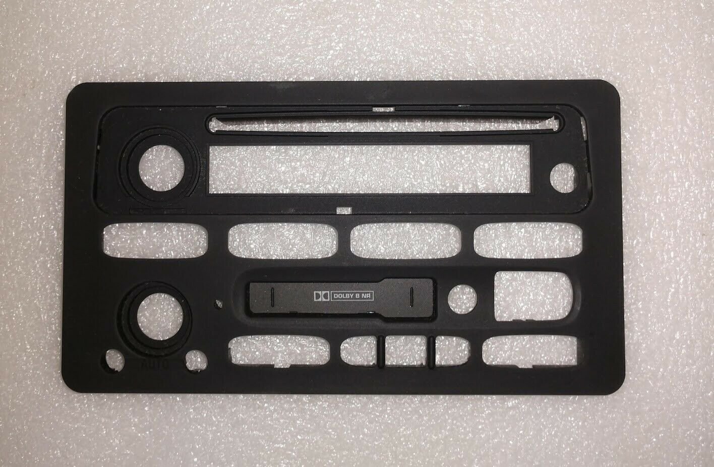 GM radio face without buttons or lens. New OEM part. Cassette and/or CD