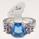 Size 7 Fashion Ring With Radiant Cut Blue Center Stone And Purple Accents